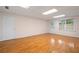 Spacious basement area with hardwood floors, bright lighting and access to the backyard at 4770 Powers Park Ne Ct, Marietta, GA 30067