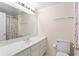 Bathroom with a long white vanity, large mirror, and shower with colorful curtain at 4770 Powers Park Ne Ct, Marietta, GA 30067