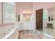 Primary bathroom with a large soaking tub, vanity area, and glass shower with decorative tile at 4770 Powers Park Ne Ct, Marietta, GA 30067