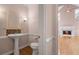 Stylish powder room with a pedestal sink, decorative mirror, and a half bath at 4770 Powers Park Ne Ct, Marietta, GA 30067