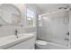 Bathroom with a glass door shower, modern vanity, and decorative round mirror at 4770 Powers Park Ne Ct, Marietta, GA 30067