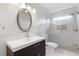 Bathroom featuring a glass shower, modern vanity, and stylish lighting at 4770 Powers Park Ne Ct, Marietta, GA 30067