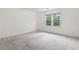 Bedroom with neutral carpeting and views of the backyard through the window at 4770 Powers Park Ne Ct, Marietta, GA 30067