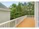 Picture of the wooden deck surrounding home with railing, overlooking a green and tree-filled backyard at 4770 Powers Park Ne Ct, Marietta, GA 30067