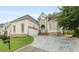 Stately home featuring manicured lawn, stone accents, and a three-car garage at 4770 Powers Park Ne Ct, Marietta, GA 30067