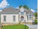Charming two-story home featuring detailed architectural elements and a manicured front lawn at 4770 Powers Park Ne Ct, Marietta, GA 30067