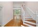 Bright foyer featuring hardwood floors, staircase, and entrance to the living area at 4770 Powers Park Ne Ct, Marietta, GA 30067