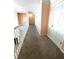 Upstairs hallway with neutral carpet and white railings at 4770 Powers Park Ne Ct, Marietta, GA 30067