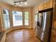 Bright kitchen area with a bay window, hardwood floors, and stainless steel refrigerator at 4770 Powers Park Ne Ct, Marietta, GA 30067