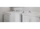 Functional laundry room equipped with a washing machine, dryer, and utility sink at 4770 Powers Park Ne Ct, Marietta, GA 30067