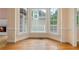 Sun-filled living room with large windows and hardwood floors offers a cozy fireplace at 4770 Powers Park Ne Ct, Marietta, GA 30067