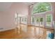 Open living room with hardwood floors, tall windows, and plenty of natural light at 4770 Powers Park Ne Ct, Marietta, GA 30067
