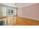 Bright living room with French doors to a balcony and light hardwood floors at 4770 Powers Park Ne Ct, Marietta, GA 30067