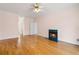 Cozy living room featuring a fireplace with green tile and light hardwood floors at 4770 Powers Park Ne Ct, Marietta, GA 30067
