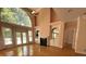 Sunlit living room with hardwood floors, fireplace, and a large arched window at 4770 Powers Park Ne Ct, Marietta, GA 30067