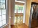 View from kitchen to sunlit living room with hardwood floors and large windows at 4770 Powers Park Ne Ct, Marietta, GA 30067