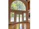 Bright living area featuring hardwood floors, a large window, and French doors at 4770 Powers Park Ne Ct, Marietta, GA 30067