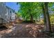 Backyard with mature foliage, tiered decks, and home exteriors at 6509 Charter Way, Lithonia, GA 30058