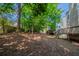 A well maintained backyard with mature foliage and tiered decking at 6509 Charter Way, Lithonia, GA 30058