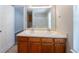 Bathroom vanity featuring double sinks and window at 6509 Charter Way, Lithonia, GA 30058