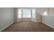 Cozy carpeted bedroom featuring a bright bay window at 6509 Charter Way, Lithonia, GA 30058