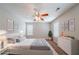 Staged bedroom with ceiling fan, modern furnishings, and natural light at 6509 Charter Way, Lithonia, GA 30058