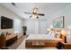 Staged bedroom with modern decor, including a bed, dresser, nightstands, and plant at 6509 Charter Way, Lithonia, GA 30058