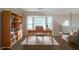 Well-lit home office with bay window, desk, and bookshelf at 6509 Charter Way, Lithonia, GA 30058