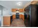 Efficient kitchen with light countertops, wooden cabinets, and modern black appliances, well-lit and functional at 6509 Charter Way, Lithonia, GA 30058