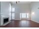 Bright living room features a fireplace, hardwood floors, and large windows at 6509 Charter Way, Lithonia, GA 30058