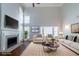 Bright, staged living room features a fireplace, wood floors, and comfortable modern furnishings at 6509 Charter Way, Lithonia, GA 30058
