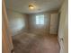 Carpeted bedroom with neutral walls, a single window, and a standard door at 6668 Prinston Cir, Douglasville, GA 30135