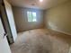 This bedroom has neutral walls and carpet and features a window that provides natural light at 6668 Prinston Cir, Douglasville, GA 30135