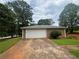 Exterior view of a one-car garage featuring a white door and neutral siding at 6668 Prinston Cir, Douglasville, GA 30135