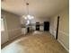 A spacious kitchen with white cabinets, black appliances, and neutral flooring at 6668 Prinston Cir, Douglasville, GA 30135