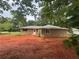 Rear exterior showcasing neutral siding, a small porch, and a spacious backyard ready for landscaping at 6668 Prinston Cir, Douglasville, GA 30135