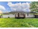 Backyard with a wooden deck, lush green lawn, and the house's exterior at , Lithonia, GA 30038