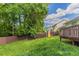 A spacious, grassy backyard enclosed by a privacy fence and mature trees at , Lithonia, GA 30038