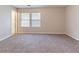 An open bedroom featuring neutral walls, plush carpeting, and two windows with blinds at , Lithonia, GA 30038