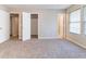 Neutral bedroom featuring plush carpet, multiple closets, and natural light from a window at , Lithonia, GA 30038