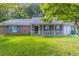 Charming brick home with a well-maintained lawn and inviting front porch, perfect for relaxing and enjoying the outdoors at , Lithonia, GA 30038