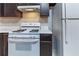 Well-equipped kitchen features a white gas range and ample counter space for preparing delicious meals at , Lithonia, GA 30038