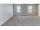 Bright living room featuring neutral paint, plush carpeting, and large windows for natural light at , Lithonia, GA 30038