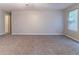 Spacious living room with neutral tones and plush carpeting offers a comfortable and versatile living space at , Lithonia, GA 30038