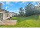 Spacious backyard featuring a concrete patio and expansive green space, perfect for outdoor activities at 1011 Riverclift Dr, Covington, GA 30016