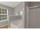 Well-lit bathroom featuring a soaking tub and a separate shower at 1011 Riverclift Dr, Covington, GA 30016
