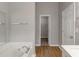 Clean bathroom with soaking tub, wood flooring and a walk-in closet at 1011 Riverclift Dr, Covington, GA 30016