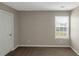 Bedroom with neutral wall color and a window for natural light at 1011 Riverclift Dr, Covington, GA 30016