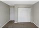 Bedroom with bi-fold closet doors and neutral color scheme at 1011 Riverclift Dr, Covington, GA 30016