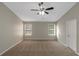 Bright bedroom with two windows and a ceiling fan at 1011 Riverclift Dr, Covington, GA 30016